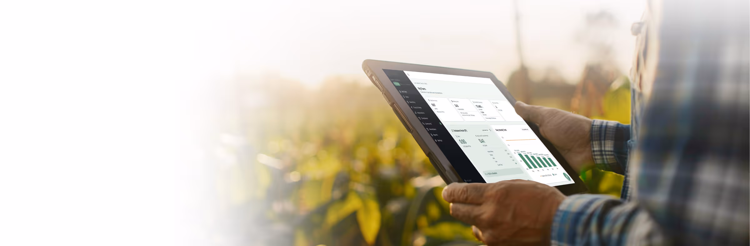 A grower holding a tablet showing the Nibbana dashboard in a field